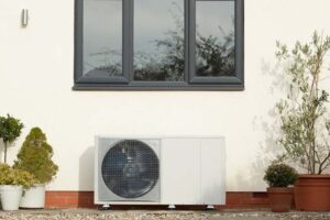 Heat pump system outside a UK home, showing the shift toward energy-efficient home heating over traditional gas boilers.