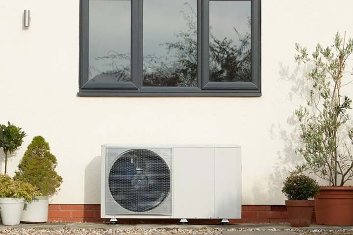 Heat pump system outside a UK home, showing the shift toward energy-efficient home heating over traditional gas boilers.