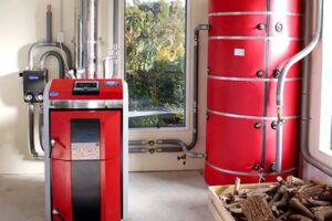Modern biomass heating system with wood pellet boiler installed in a UK home.