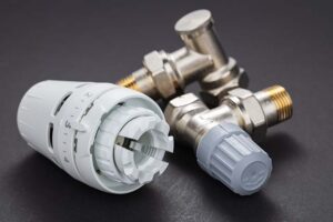 Person replacing a TRV radiator valve using tools in a UK home