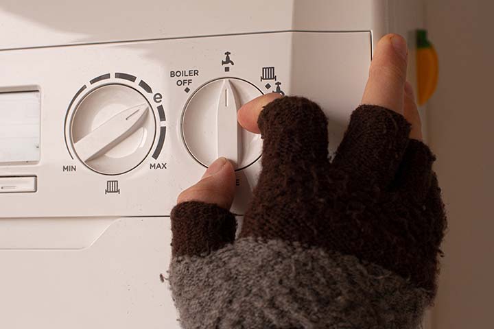 Modern combi boiler installed in a UK home showing display panel and pipes